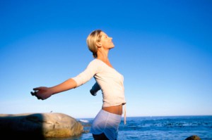 Woman stretching by ocean