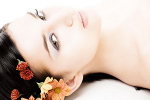 Close-up of beautiful face with flowers. On white background